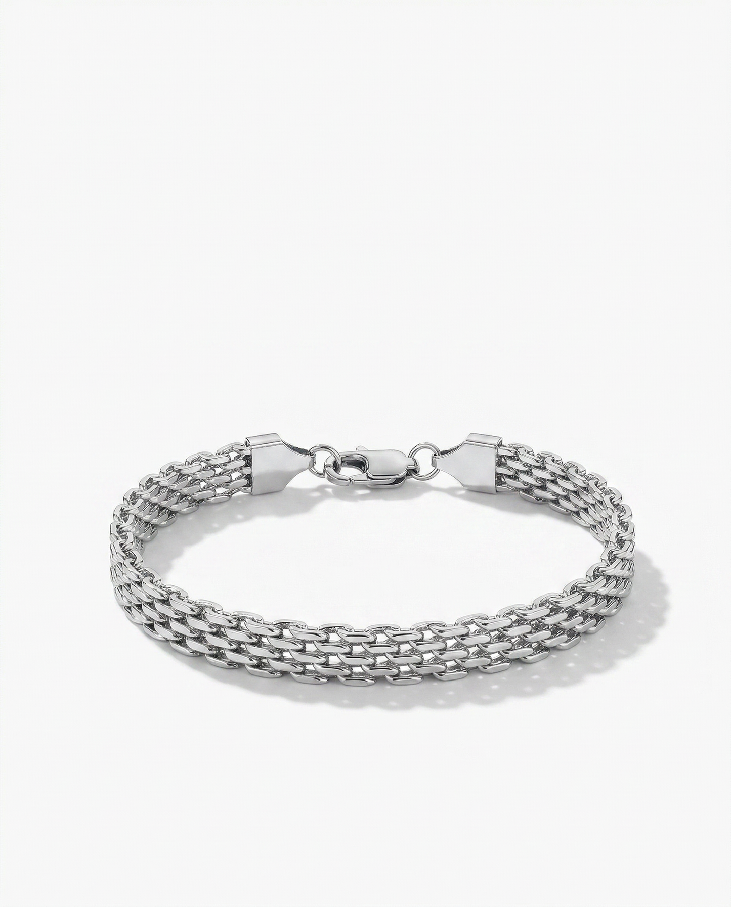 Silver flat woven wide link chain bracelet lying flush against wrist Ð FOUND Jewelry Canada
