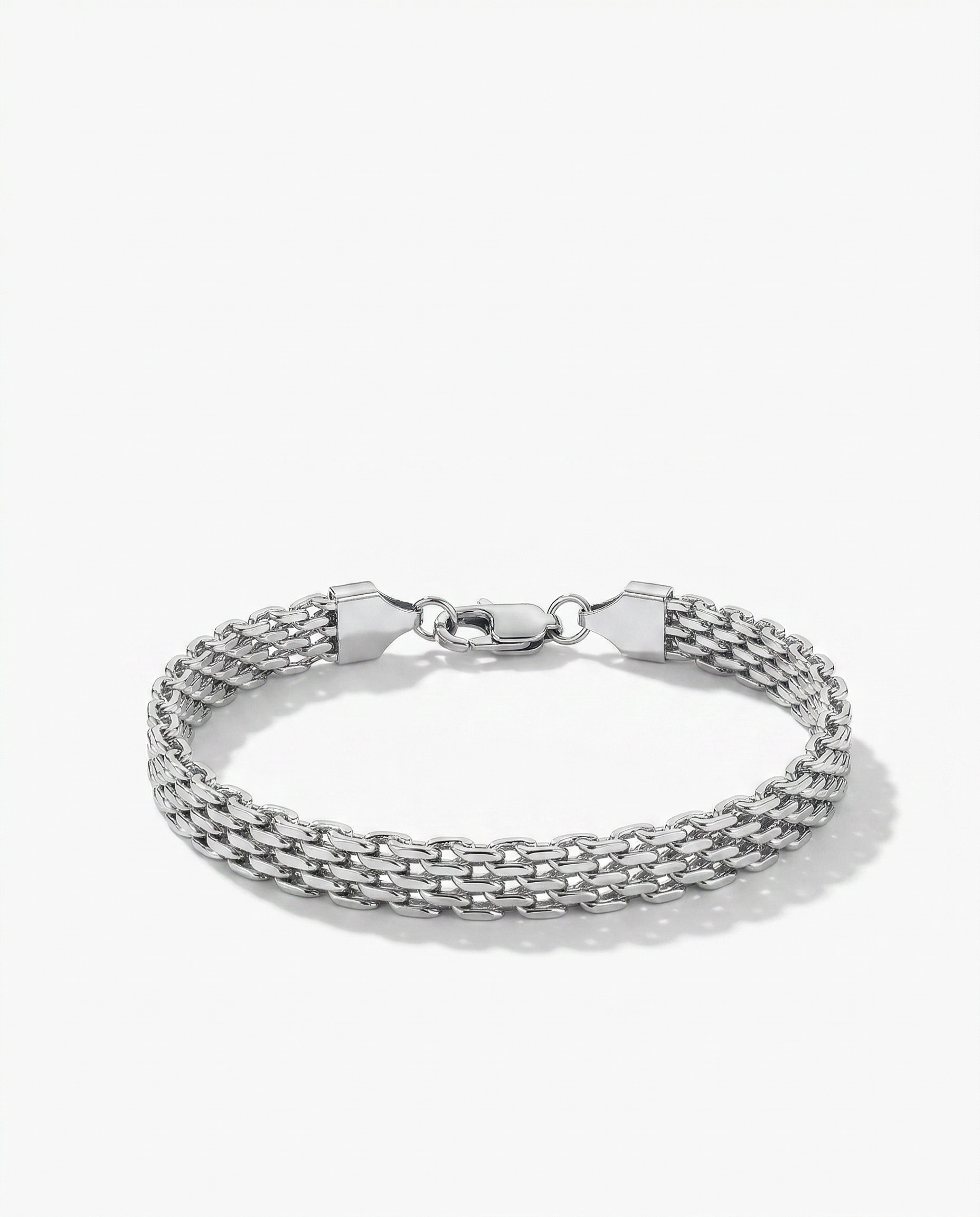 Silver flat woven wide link chain bracelet lying flush against wrist Ð FOUND Jewelry Canada