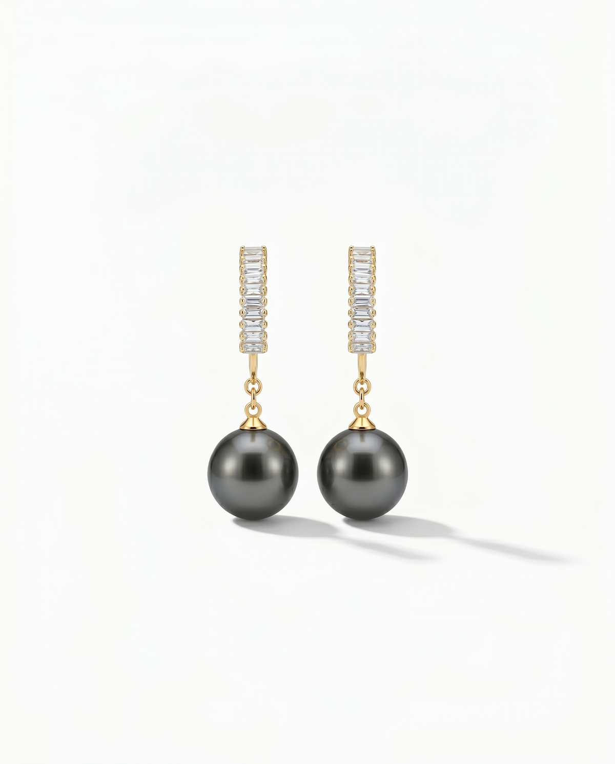 Gold baguette zirconia hoop earring with large dark Tahitian pearl drop hanging below - FOUND Jewelry Canada